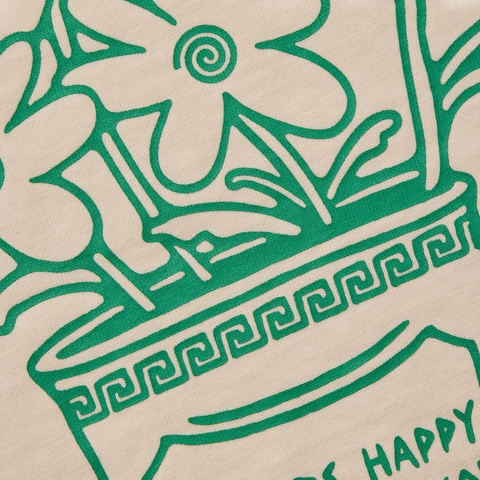 Green floral design on a beige long sleeve t shirt. 