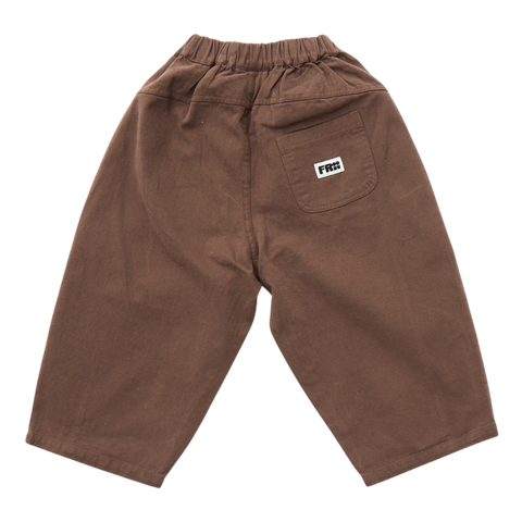 Brown pants with a frii logo on the pocket against a white background